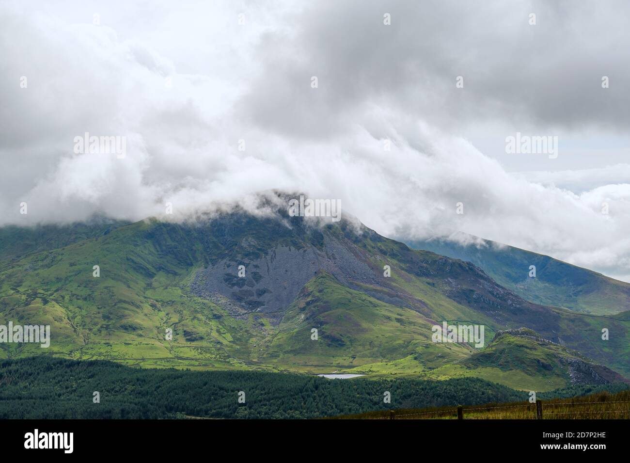 Panoramic view at Yr Wyddfa - Snowdon on cloudy day from Ranger Path. Highest mountain range in Wales covered in clouds. Snowdonia National Park. UK. Stock Photo
