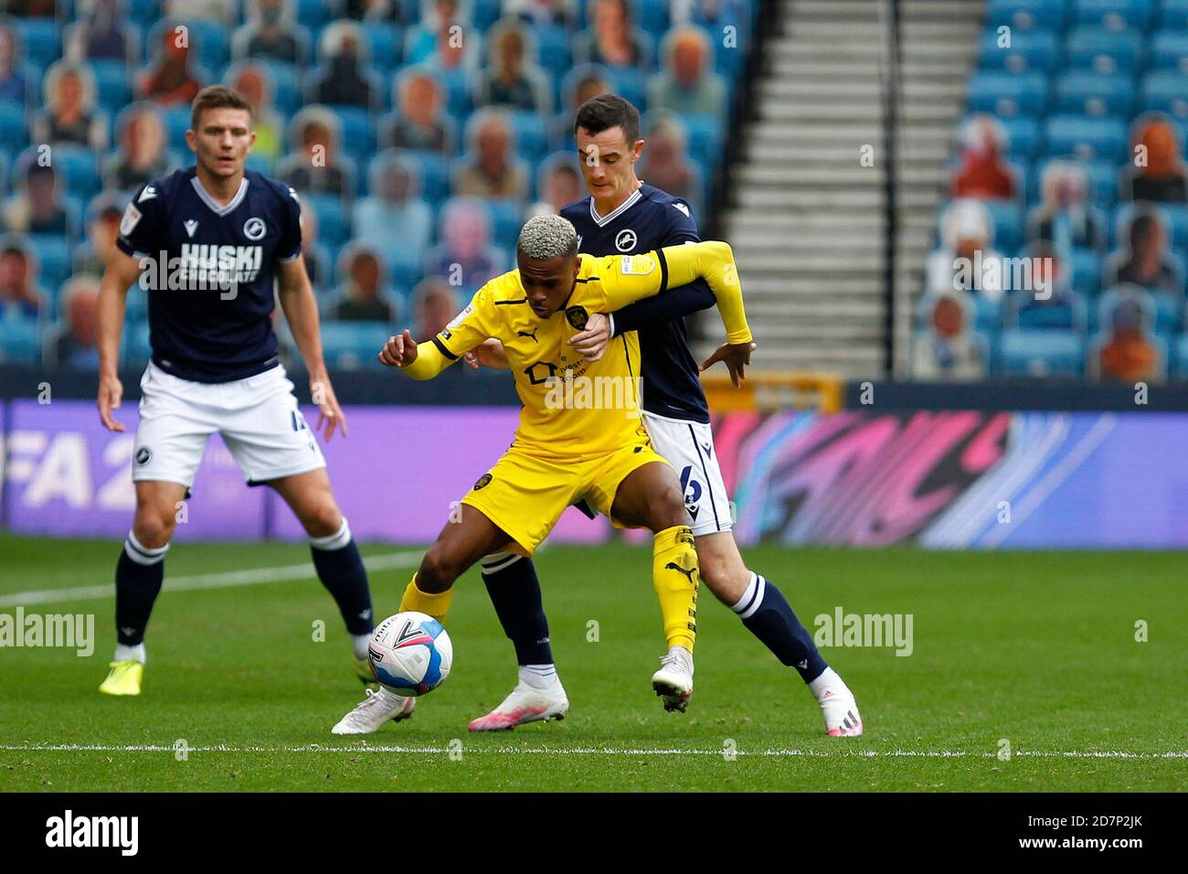 London, UK. 24th Oct, 2020. Elliot Sim›es of Barnsley holds off Shaun Williams of Millwall during the Sky Bet Championship match played behind closed doors due to government Covid-19 guidelines between Millwall and Barnsley at The Den, London, England on 24 October 2020. Photo by Carlton Myrie. Credit: PRiME Media Images/Alamy Live News Stock Photo