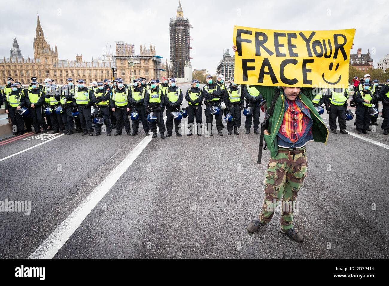 London, UK. 24th Oct, 2020. A man with a placard stops on Westminster Bridge. Unite For Freedom movement organised a protest under the banner, We Have The Power, to show the forces that, they do not consent in what they see as an unlawful lockdown. Credit: Andy Barton/Alamy Live News Stock Photo