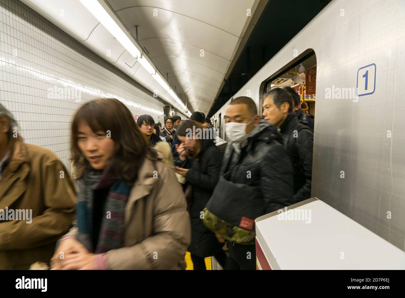 Commuters get out from the Toei Oedo Line at Morishita Station at Tokyo ...