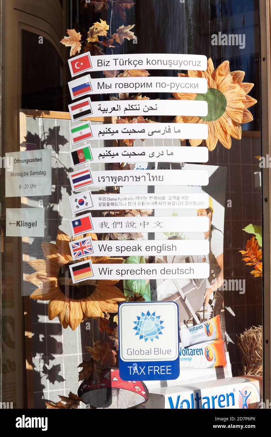Several languages on the window of a pharmacy in Berlin Stock Photo