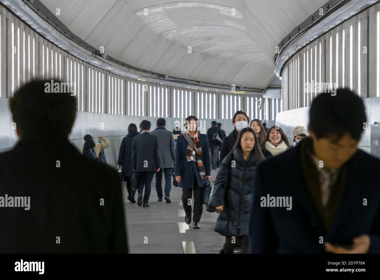 Commuters walk on the passageway at Toei Oedo Line Iidabashi Tokyo ...