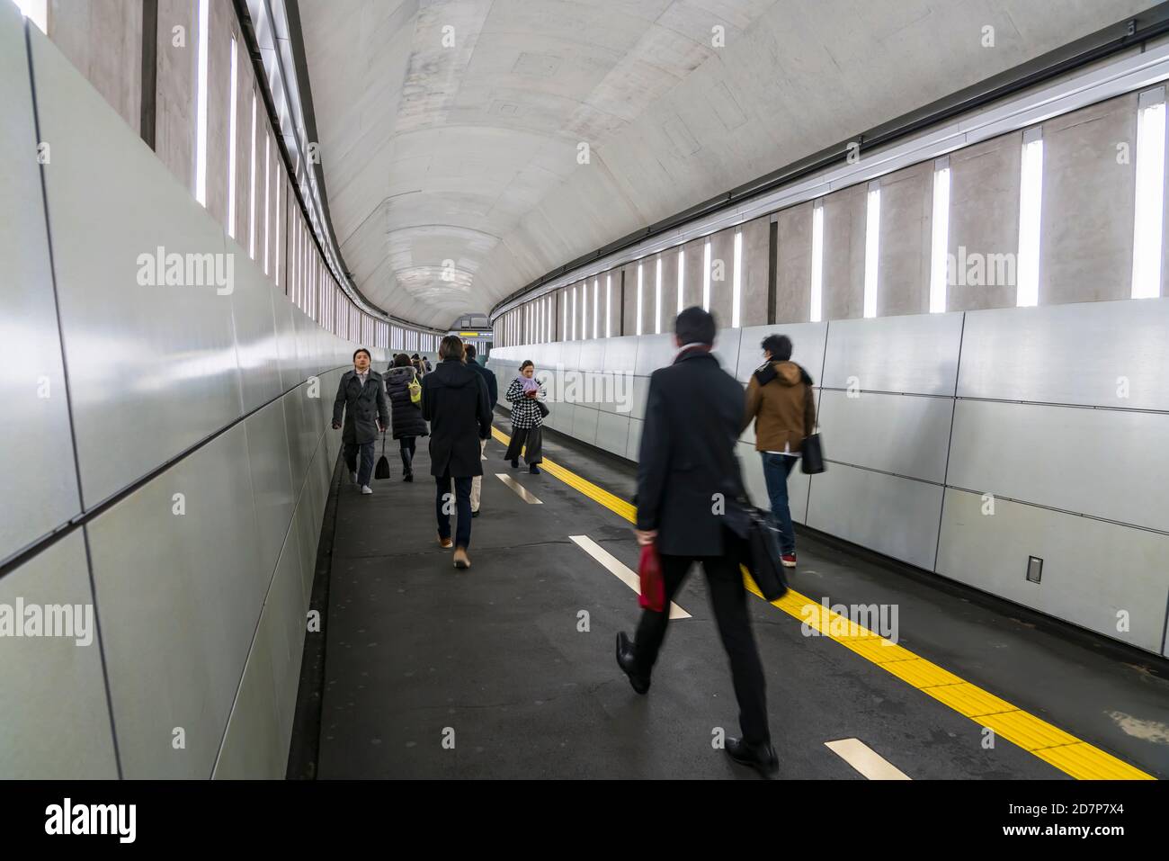 Commuters walk on the passageway at Toei Oedo Line Iidabashi Tokyo ...