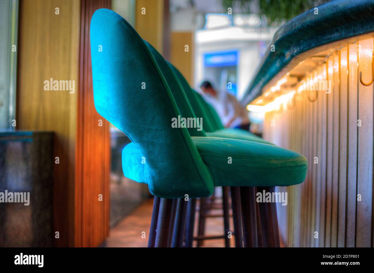 Row of velvet stools in a restaurant. Stock Photo
