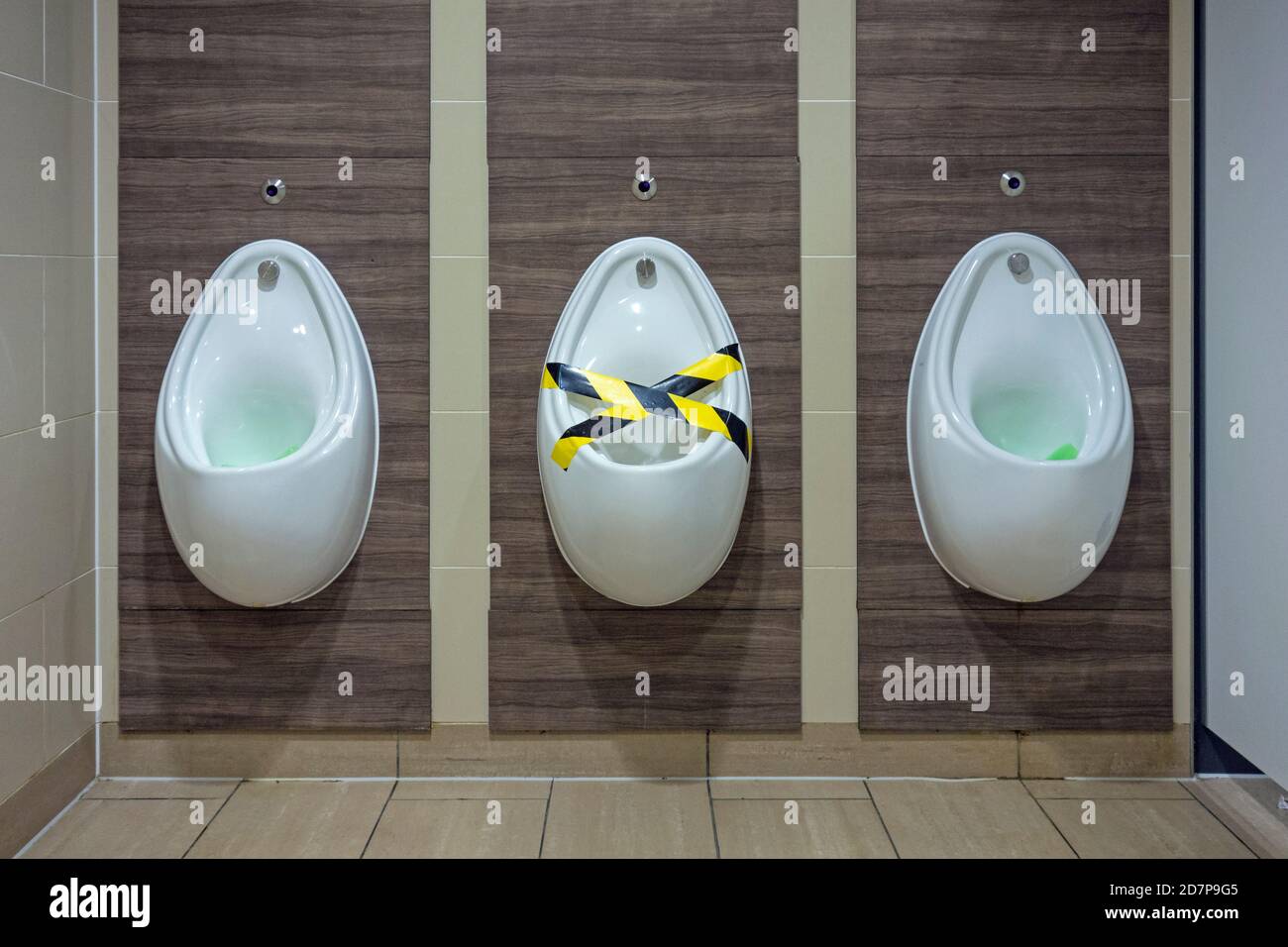 Gentlemen's urinals with one urinal taped off, Edinburgh Airport, Scotland Stock Photo