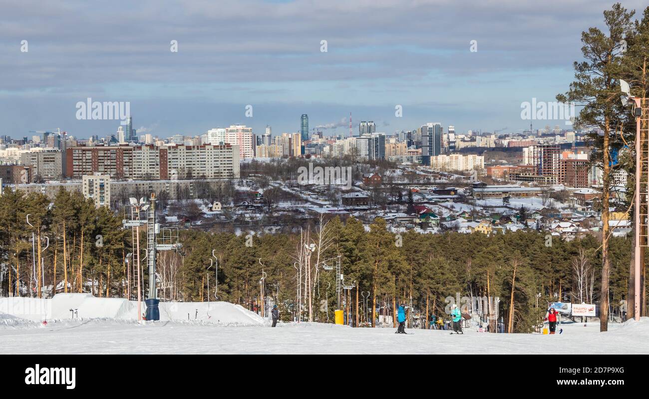 Yekaterinburg, Russia - February 26, 2019. The training ski slope of the sports complex on Uktus Mountain over the background a pine forest and a pano Stock Photo