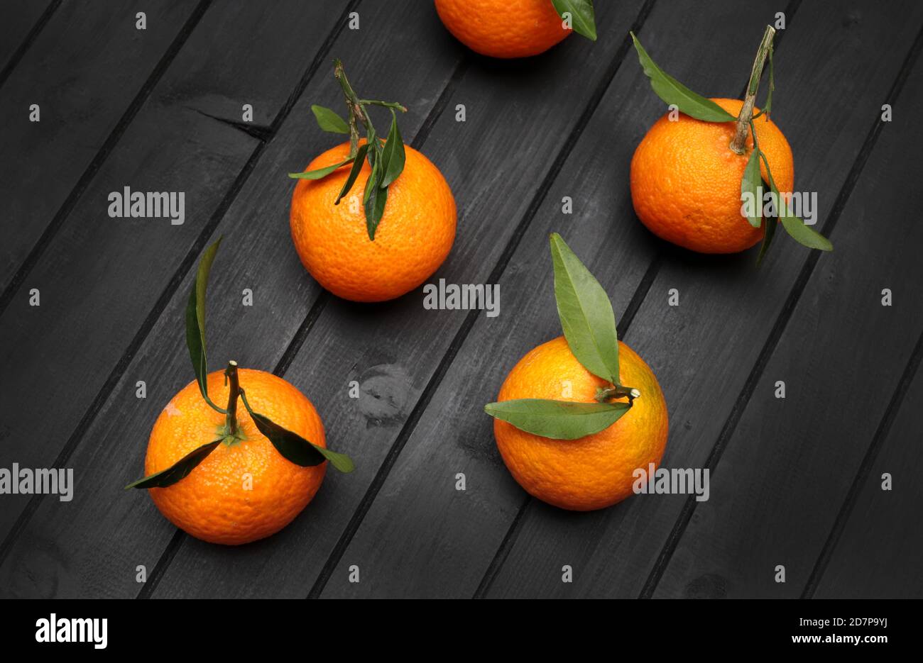 Mandarins fruit isolated on dark background. Top view. Stock Photo