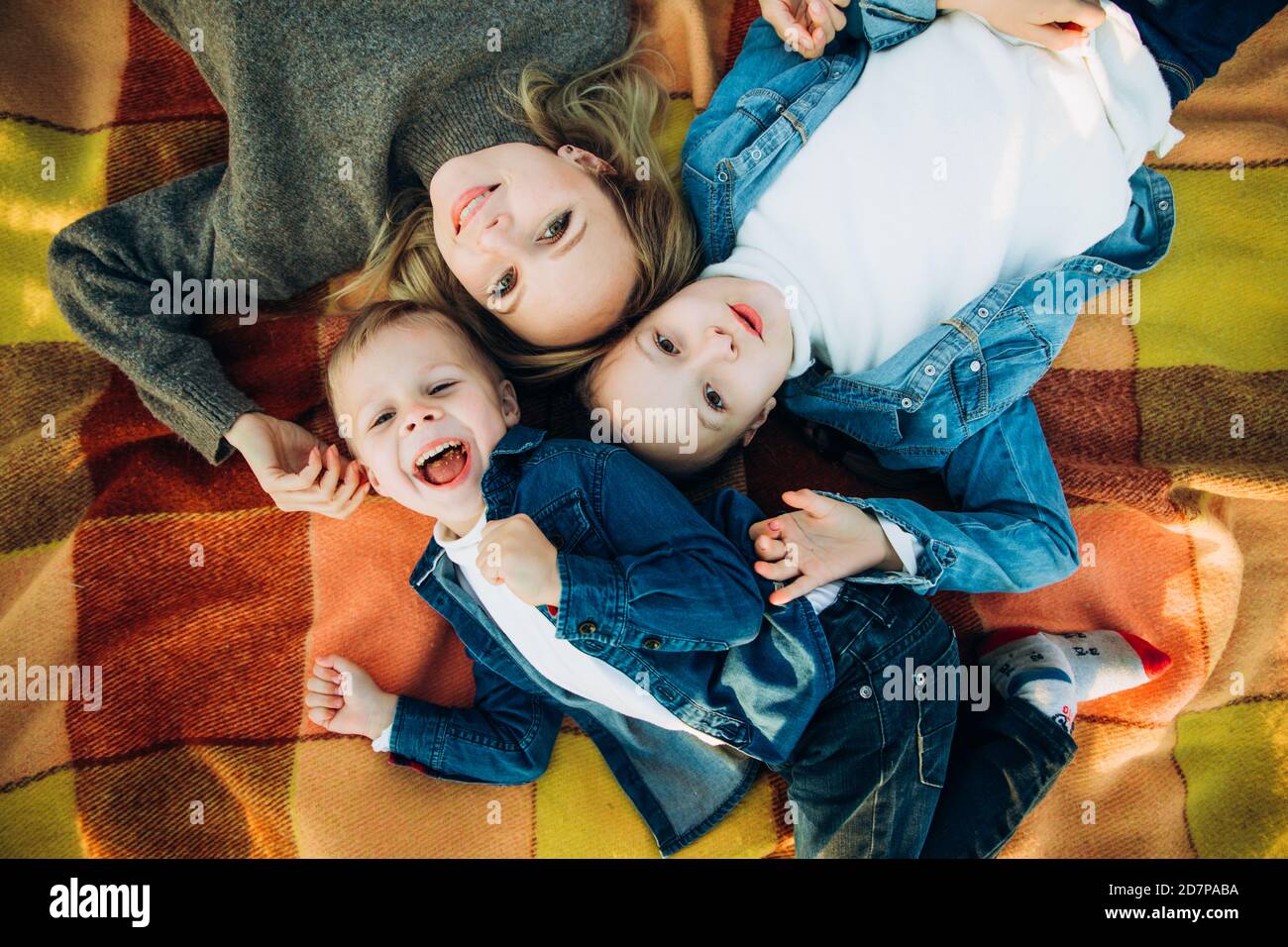 A happy family is smiling and looking up. Family on a picnic Stock