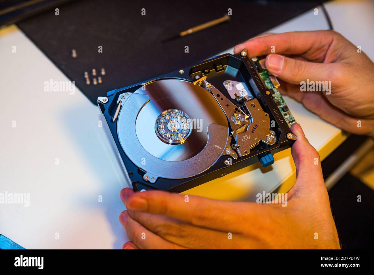 External hard drive open for reparation in mens hand Stock Photo