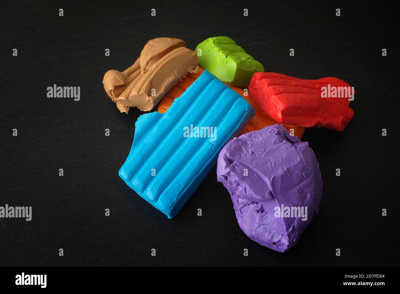 Colorful polymer clay on a black background. Close up. Stock Photo