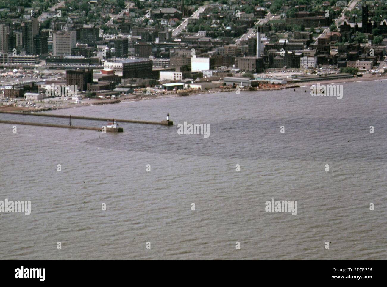 The St. Louis River basin discharges its waters into Lake Superior through the Duluth Ship Canal. The river waters show as the dark patch on the lake (in or near Duluth Minnesota) ca. 1973 Stock Photo