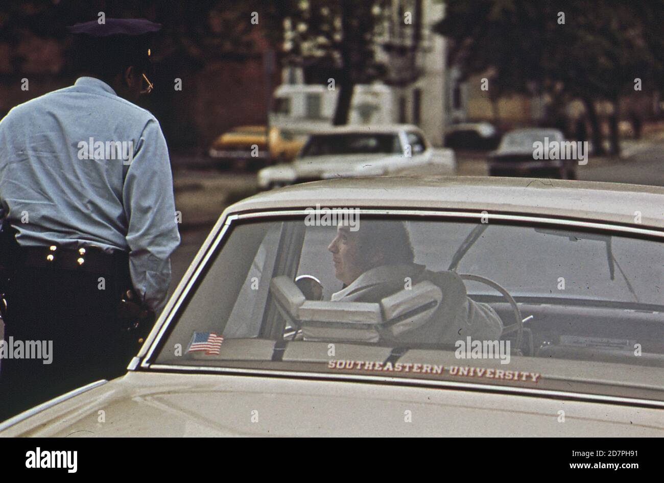 Officer warns driver that his exhaust is emitting too much smoke (Washington D.C.)   ca. 1973 Stock Photo