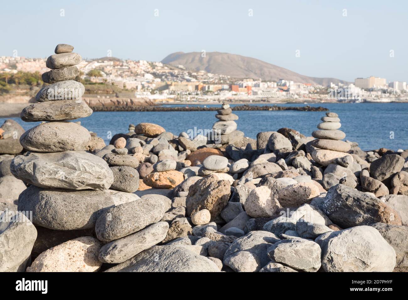 Piles of stones balanced, stacked in a pyramid on a beach in Costa Adeje, Tenerife, Canary Islands Stock Photo