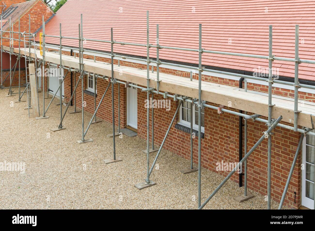 Scaffolding outside a UK house extension, barn conversion to single storey bungalow Stock Photo