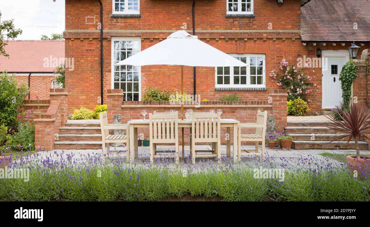 Large UK country house with garden furniture on a patio in a back garden Stock Photo