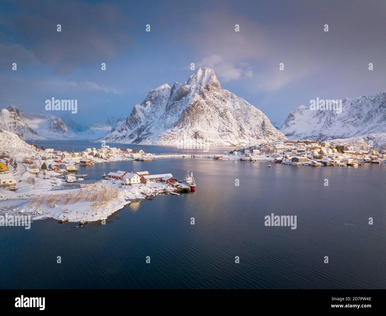 Fishing village Reine in winter at dawn, snowy landscape, Reinefjord, Moskenesoya, Nordland, Lofoten, Norway Stock Photo