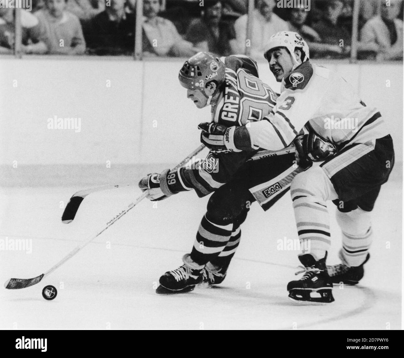 Edmonton Oilers Wayne Gretzky, left, is held on by Buffalo Sabres Hannu Virta during a NHL hockey game in Buffalo, New York on January 13, 1985. Photo by Francis Specker Stock Photo