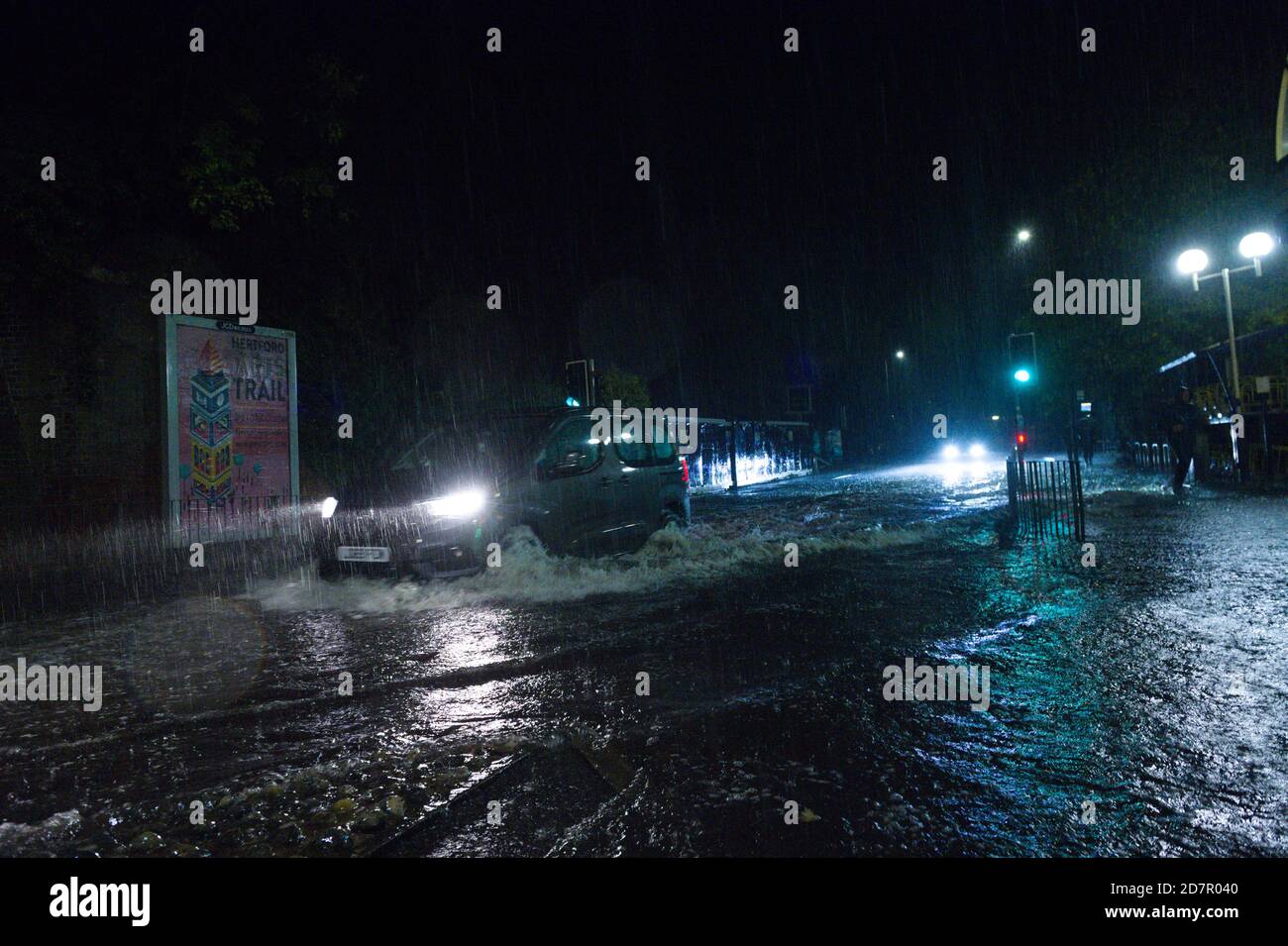 Hertford, UK. 24th June 2020. Heavy rainfall in Hertford, UK. The Met Office has issued a yellow warning for wind and rain in the south east. The rain has caused flooding in areas and was the water was as deep aws some cars bonnets outside of Hertford North railway station. Credit: Andrew Steven Graham/Alamy Live News Stock Photo