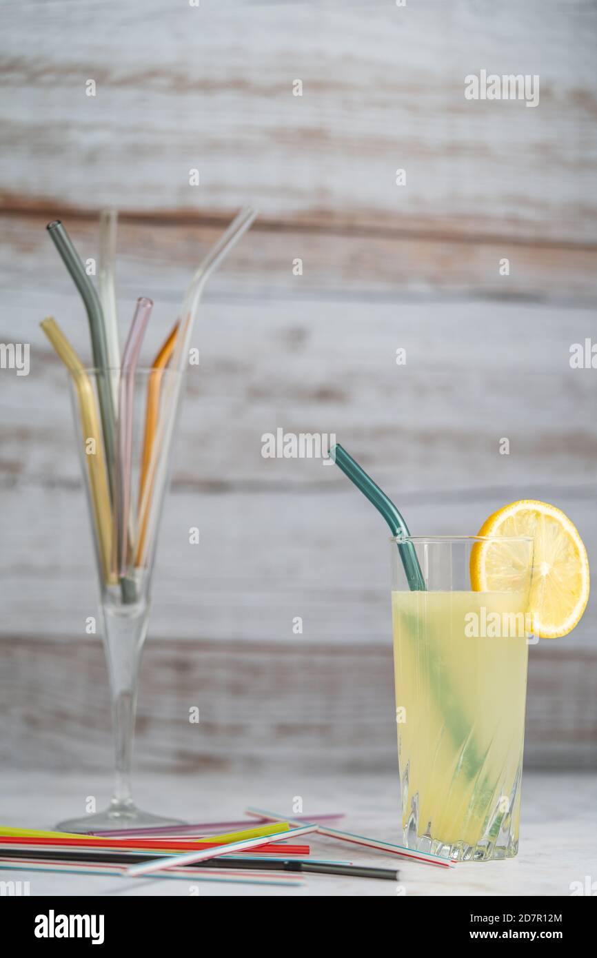 Lemonade with glass straw. Glass straws replacing plastic straws in