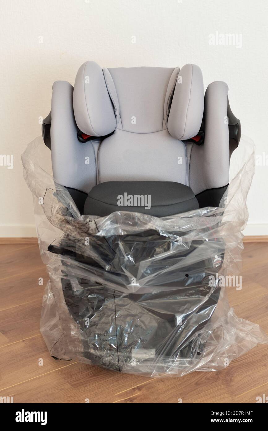 Unpacking a baby gray car safety seat Stock Photo