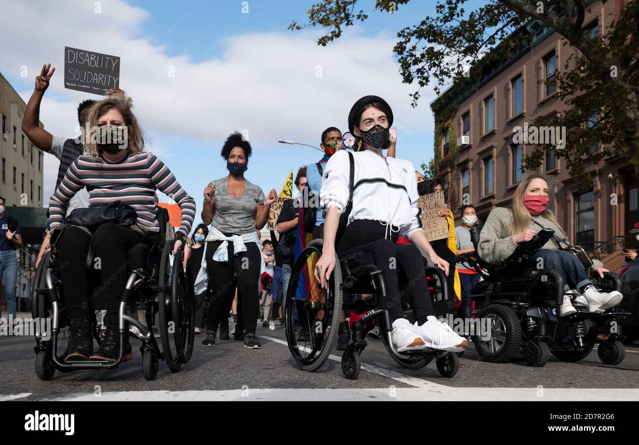 New York, New York, USA. 24th Oct, 2020. GG DEFIERBRA, LEFT AND BRI SCALESSE participate in the Black Disabled Lives Matter protest in New York, New York. The demonstrators Marched down Harlem streets to Marcus Garvey park and gave speeches on the life of disabled persons. Credit: Brian Branch Price/ZUMA Wire/Alamy Live News Stock Photo