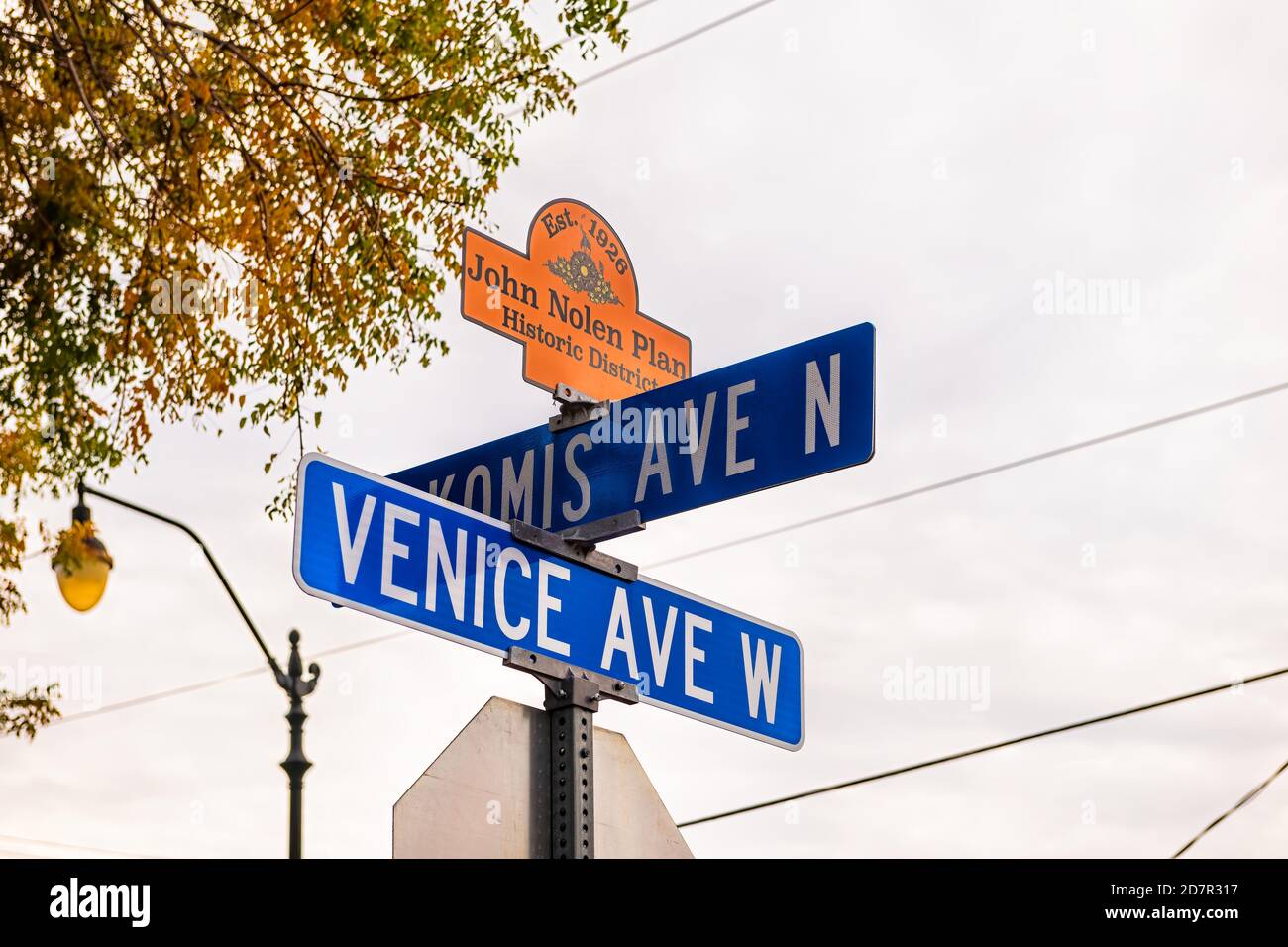 Venice, USA - April 29, 2018: Sign post in small Florida city town in gulf of Mexico with cloudy sky and text for west avenue historic district John N Stock Photo