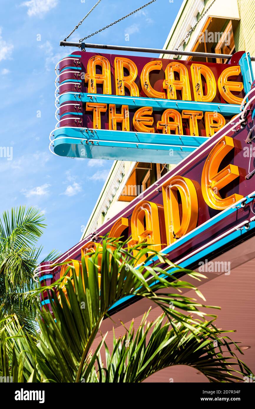 Fort Myers, USA - April 29, 2018: City street during sunny day in Florida gulf of mexico coast with retro vintage sign for Arcade theatre Stock Photo