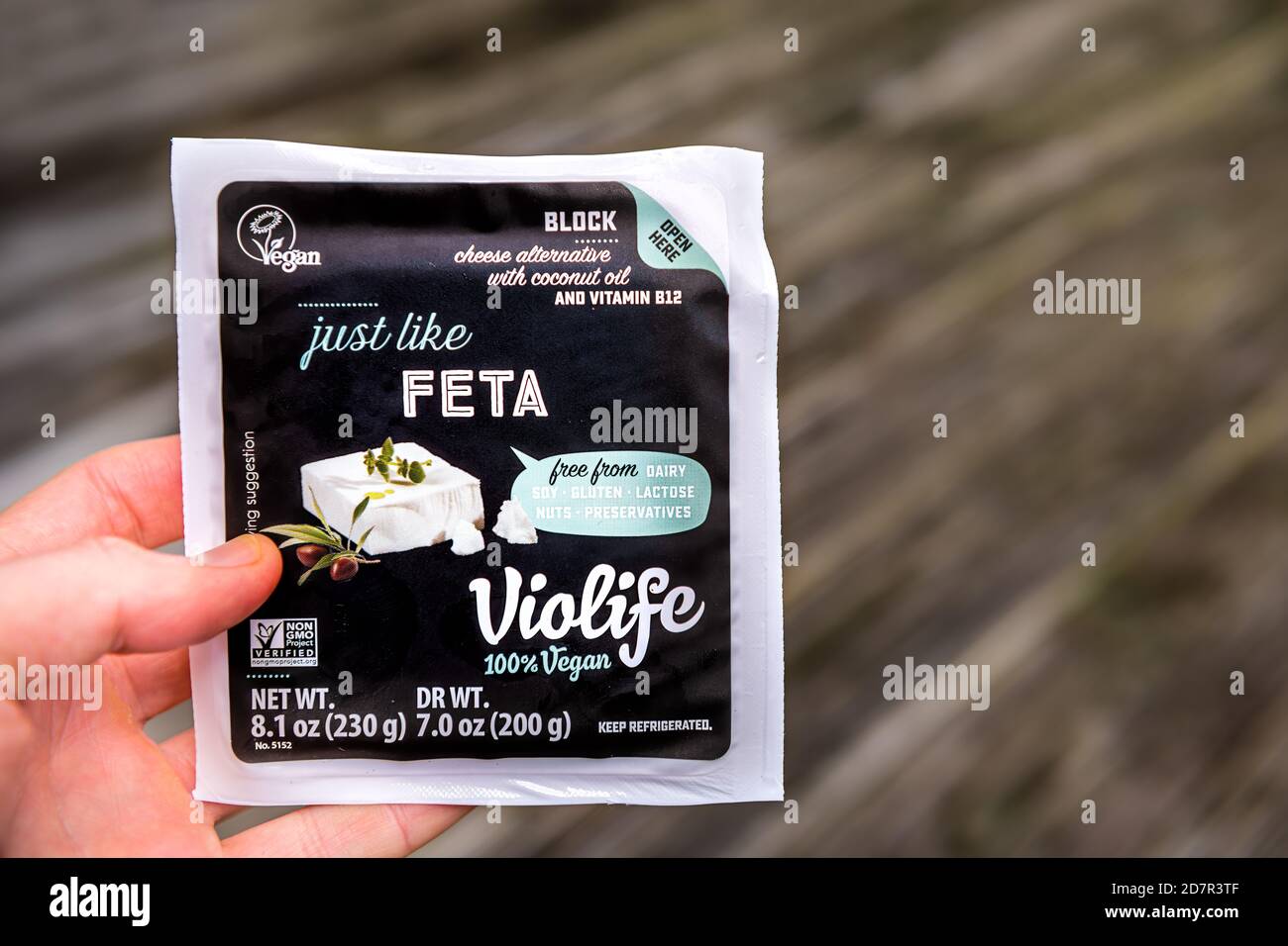 Herndon, USA - September 4, 2020: Closeup of hand holding vegan food packaged Greek feta Violife cheese in package with sign text for dairy free block Stock Photo