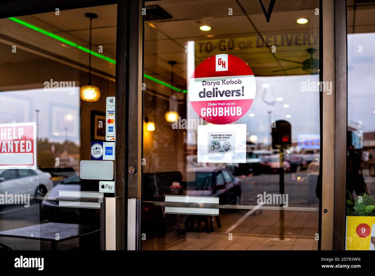 Sterling, USA - September 9, 2020: Sign for Darya Kabob business door entrance on window with text for Grubhub delivery takeout and help wanted in Vir Stock Photo