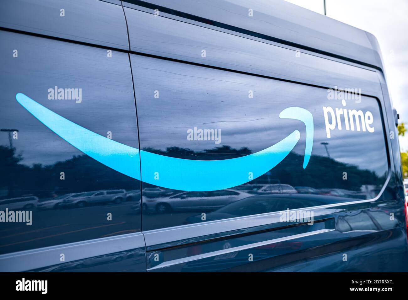 Sterling, USA - September 12, 2020: Amazon delivery van car vehicle parked on parking lot of Walmart retail store with Prime logo on car closeup Stock Photo