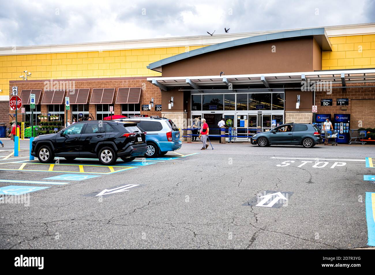 Sterling, USA - September 12, 2020: Walmart store entrance with shopping consumerism in Virginia and cars in parking lot Stock Photo