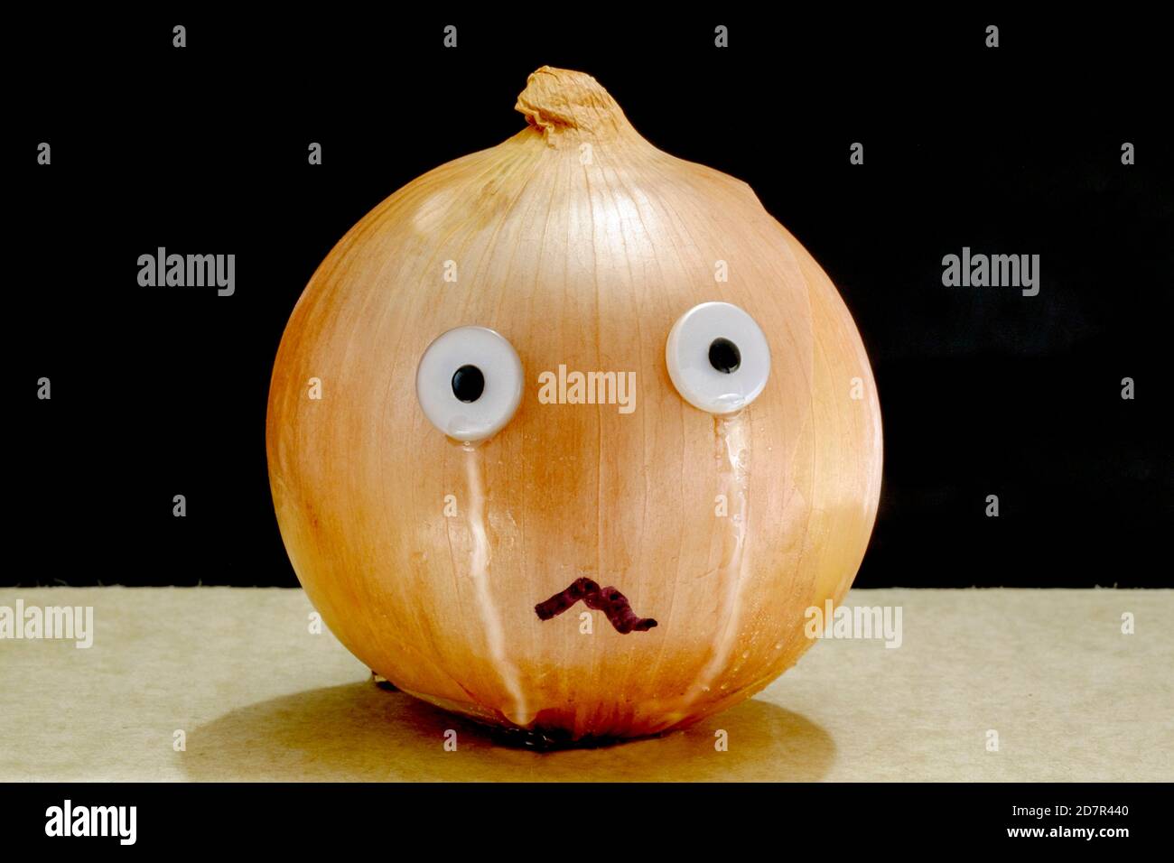 Humorous depiction of a crying onion, a parody on onions causing tears