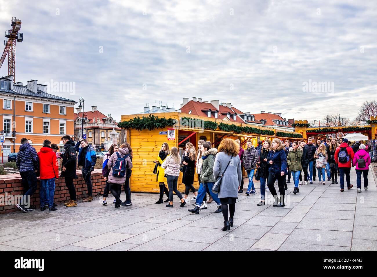 Warsaw, Poland - December 18, 2019: Old town Warszawa with Christmas market near royal castle square and school field trip group of students walking b Stock Photo