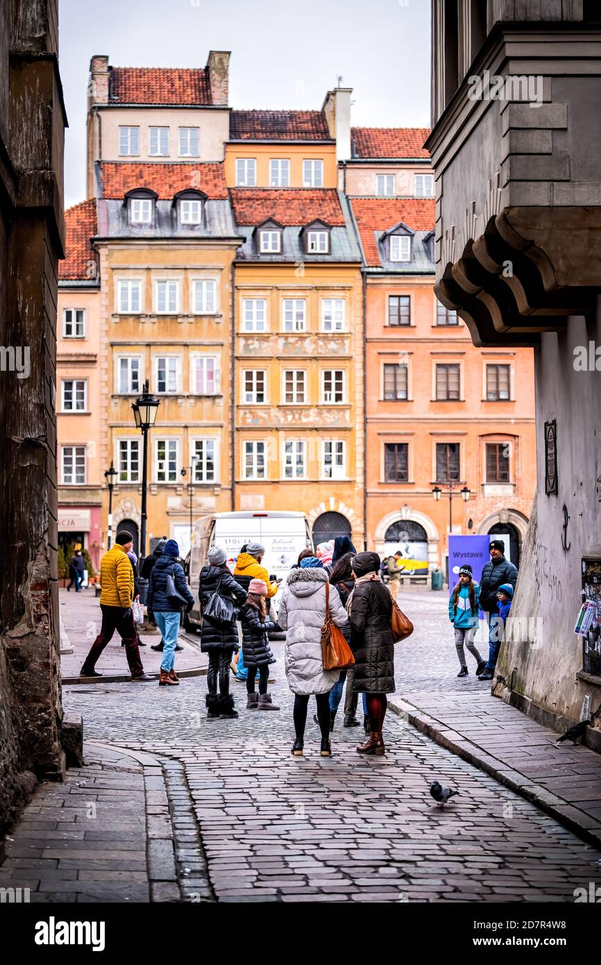 Warsaw, Poland - December 25, 2019: Waski Dunaj narrow alley cobblestone  street between colorful buildings with people walking to Warszawa old town  ma Stock Photo - Alamy