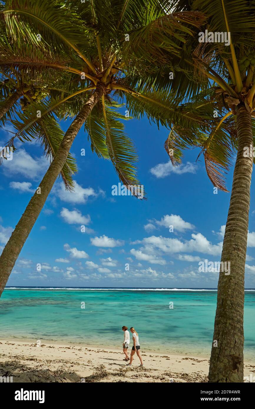 Coconut palm trees and beach, Takitimu District, Rarotonga, Cook Islands, South Pacific (model released) Stock Photo