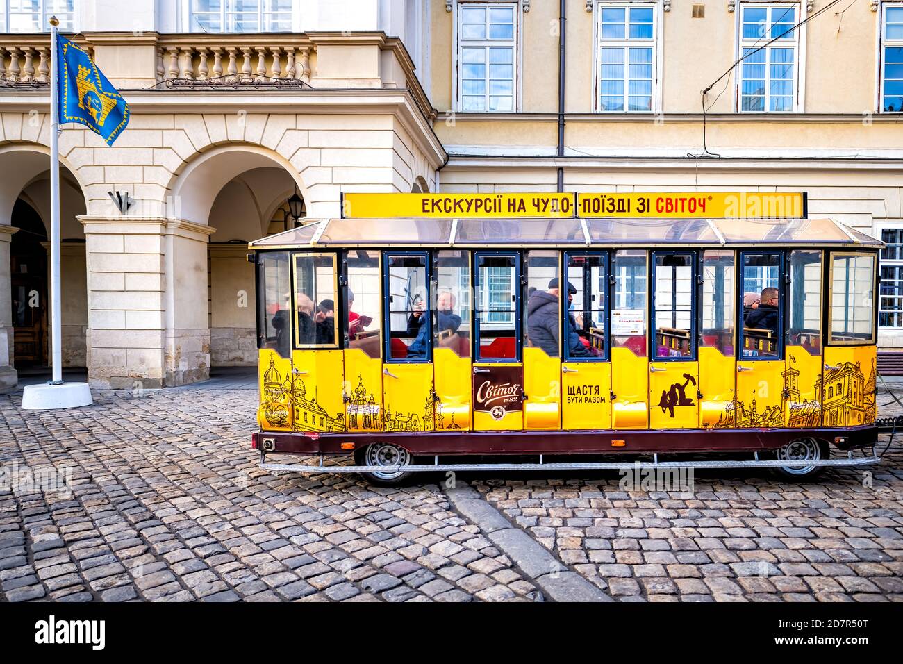 Lviv, Ukraine - January 21, 2020: Ukrainian Lvov city in old town with people sitting inside car of Svitoch sponsored guided tram tramway car tour at Stock Photo