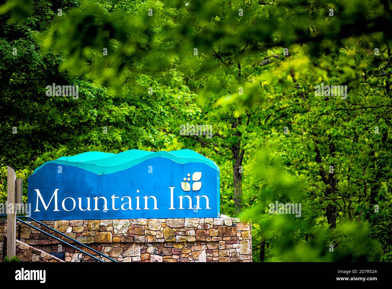Wintergreen, USA - June 9, 2020: Green summer at ski resort town village with sign at entrance for Mountain Inn in Blue Ridge mountains in summer Stock Photo