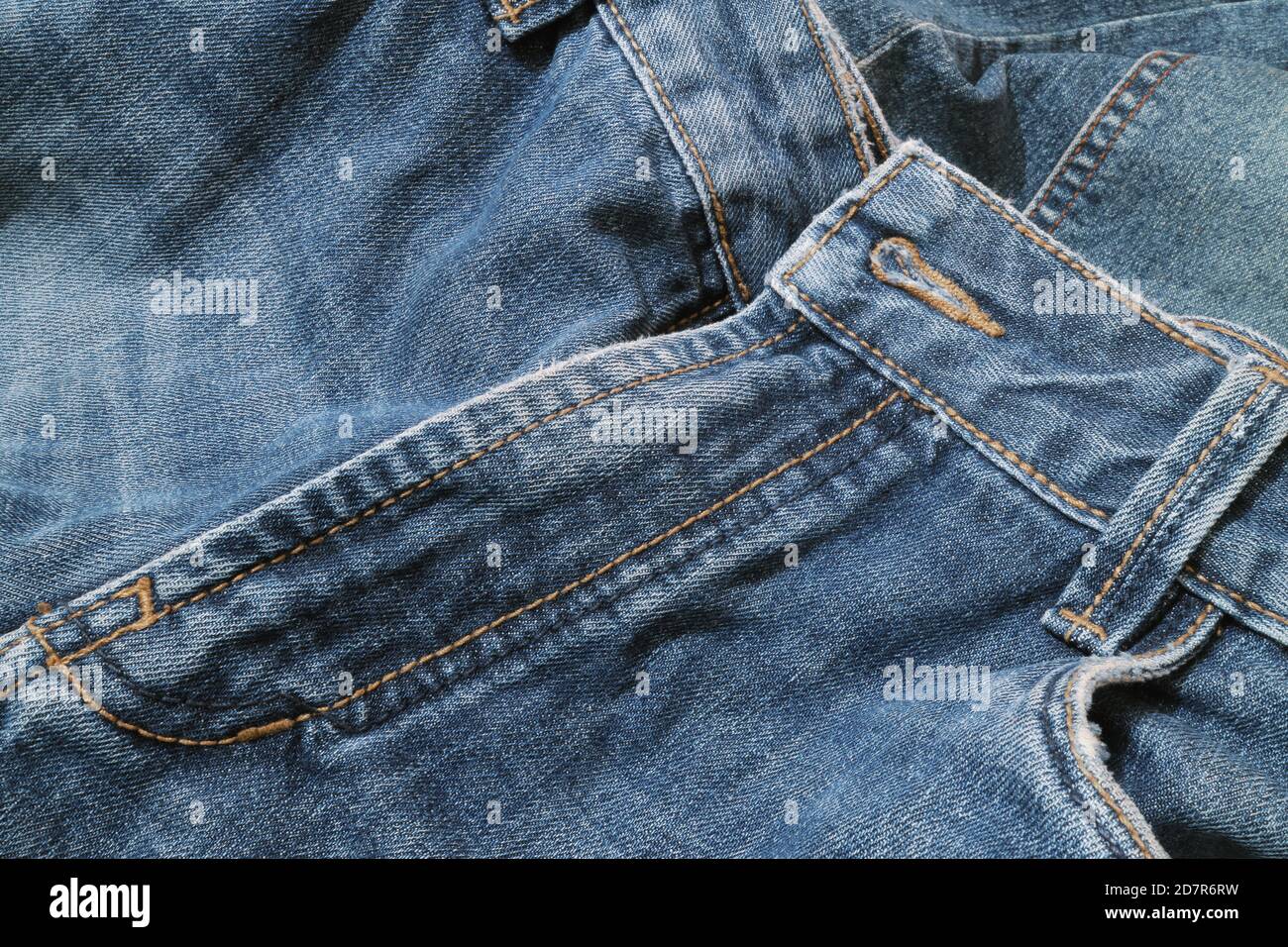 Textured background of blue denim jeans with seam and thread stitch ...