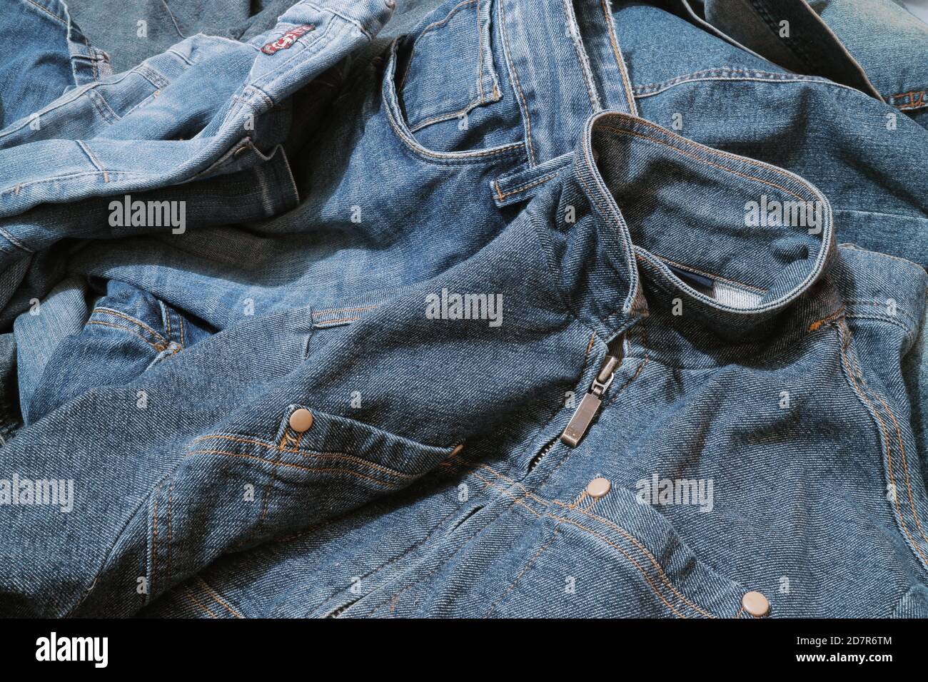 Textured background of blue denim jeans with seam and thread stitch. Stock Photo