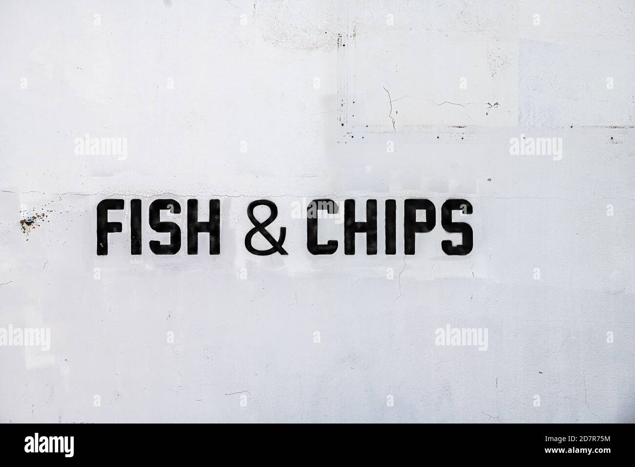 Restaurant pub menu sign on street white building wall outside closeup with black text for fish and chips food Stock Photo