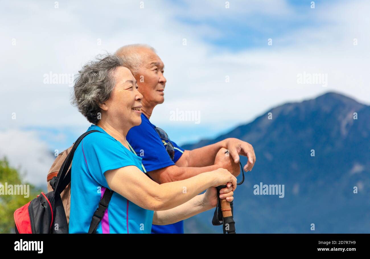 happy asian senior couple hiking in nature Stock Photo - Alamy