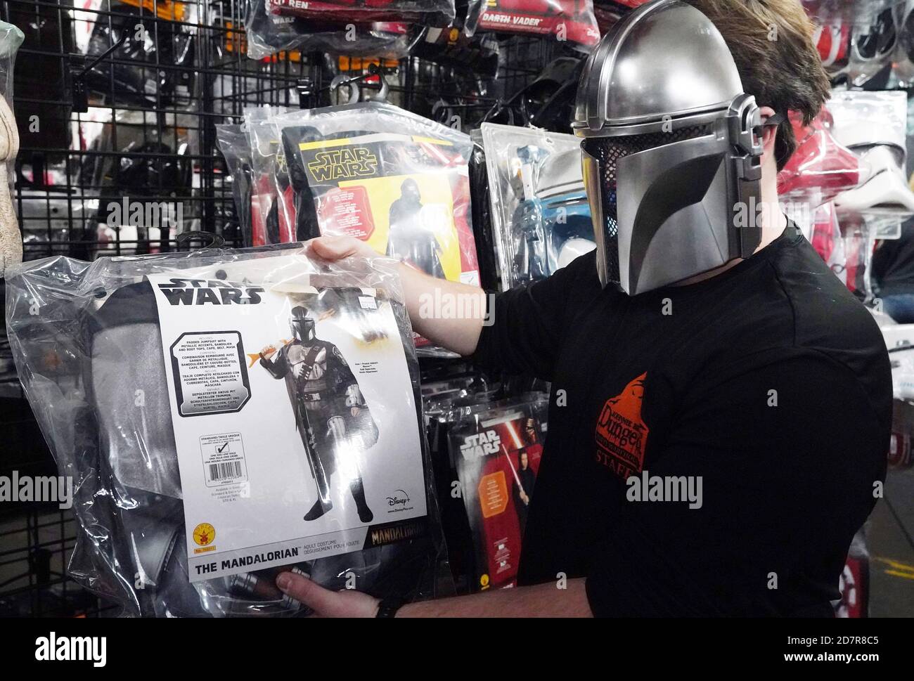 St. Louis, United States. 24th Oct, 2020. Manager Jacob Singmond checks the availability of the new Starwars Mandalorian costume for Halloween while wearing the mask, at Johnnie Brock's Dungeon, in St. Louis on Saturday, October 24, 2020. Photo by Bill Greenblatt/UPI Credit: UPI/Alamy Live News Stock Photo