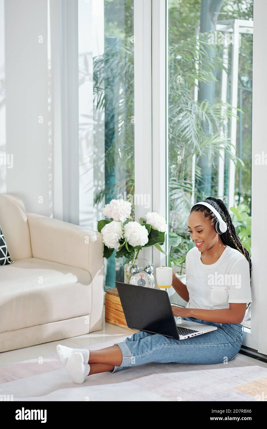 Smiling woman working on laptop Stock Photo