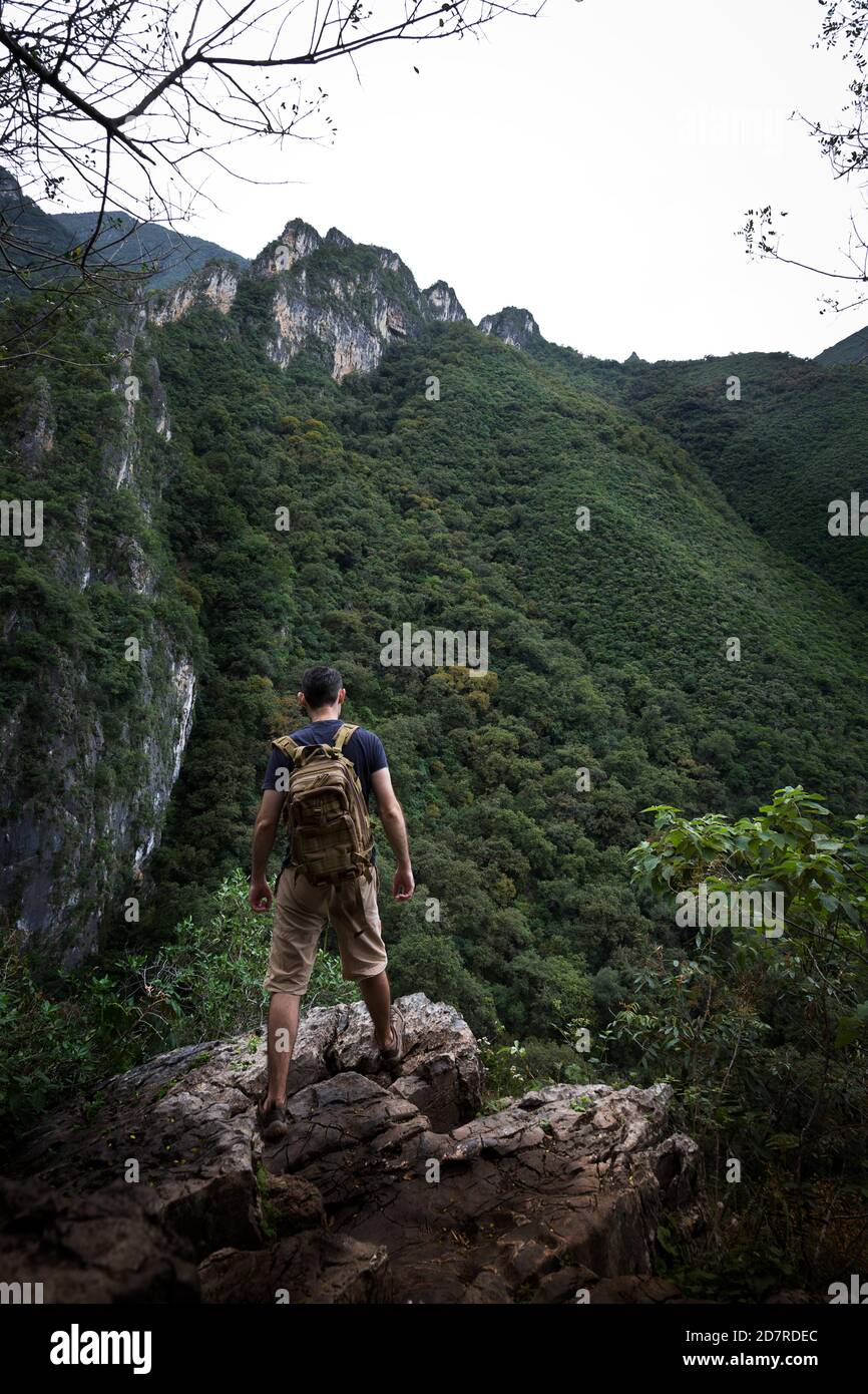 man observing the view standing in a rock in La Estanzuela Monterrey Natural Park in Mexico Stock Photo