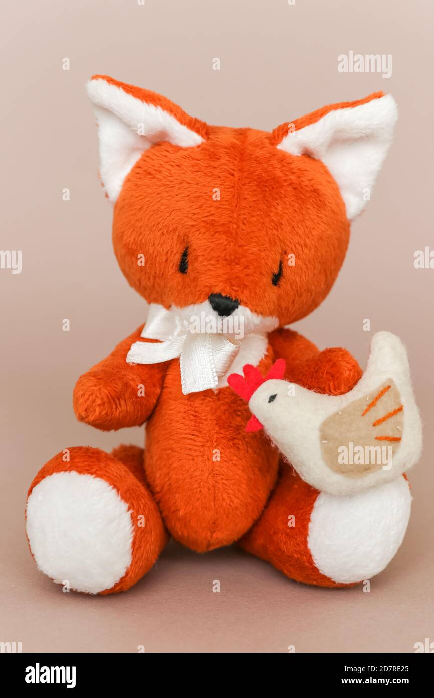 Soft toy ginger fox with chicken on a light background Stock Photo Alamy