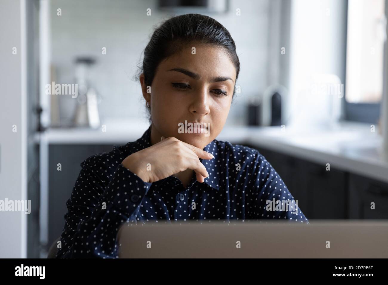 Pensive Indian woman think working on laptop Stock Photo - Alamy