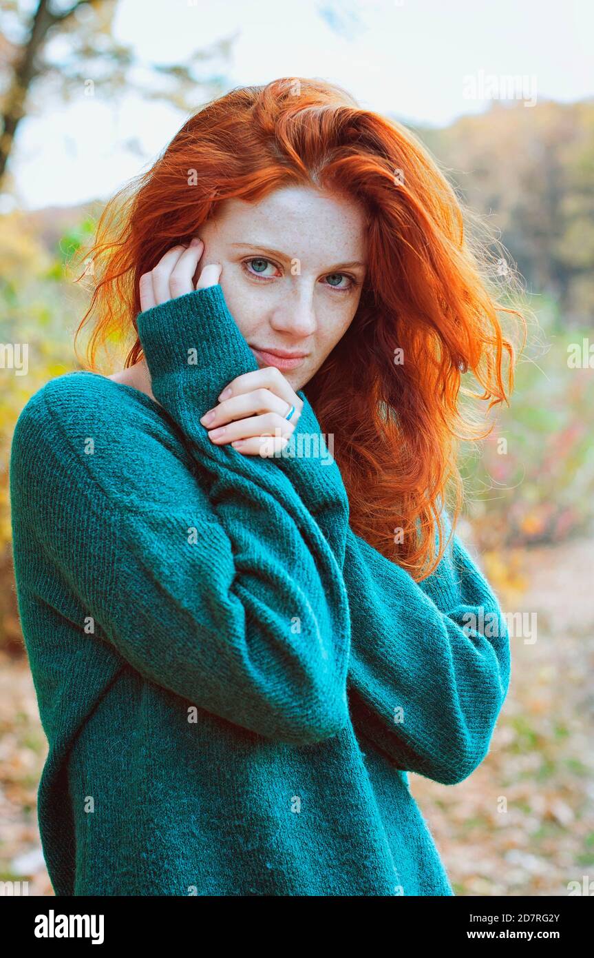 Portrait of a beautiful red-haired girl with freckles and blue eyes in  colorful autumn park Stock Photo - Alamy