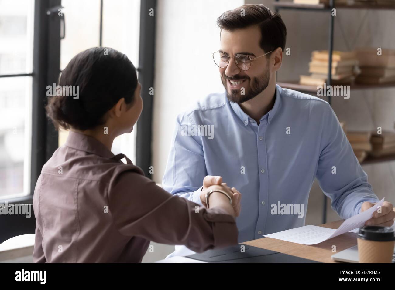 Smiling diverse businesspeople handshake greeting at meeting Stock Photo