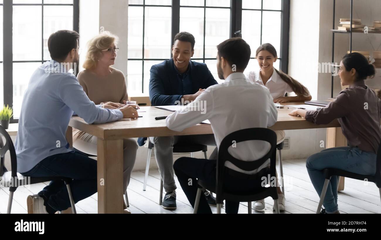 Smiling multiracial employees have fun brainstorming at meeting Stock ...
