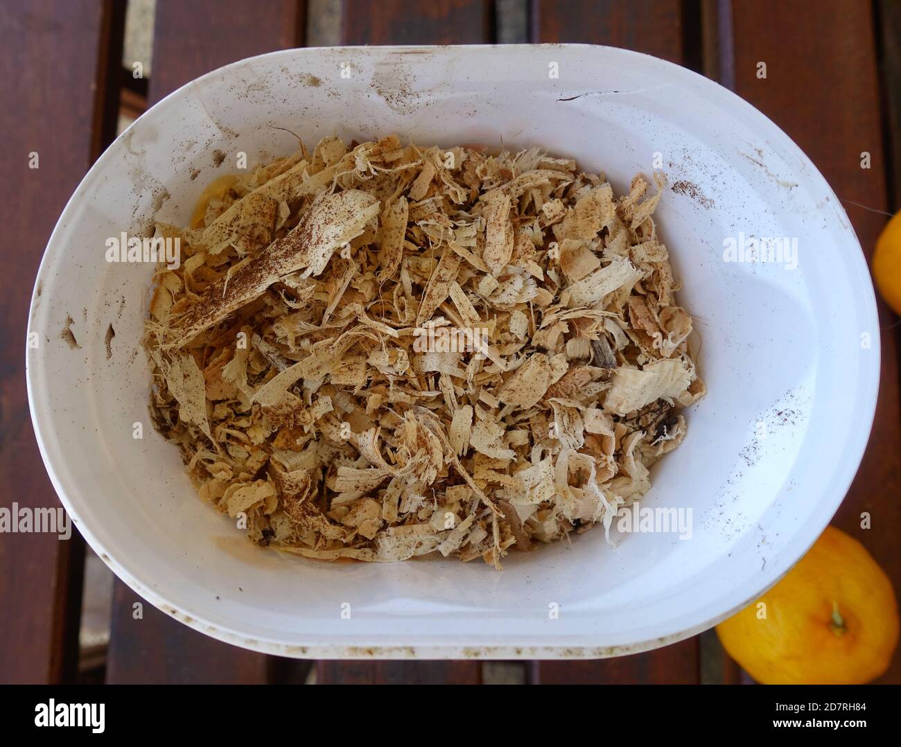 Container of wood shavings to be used for gardening. Stock Photo